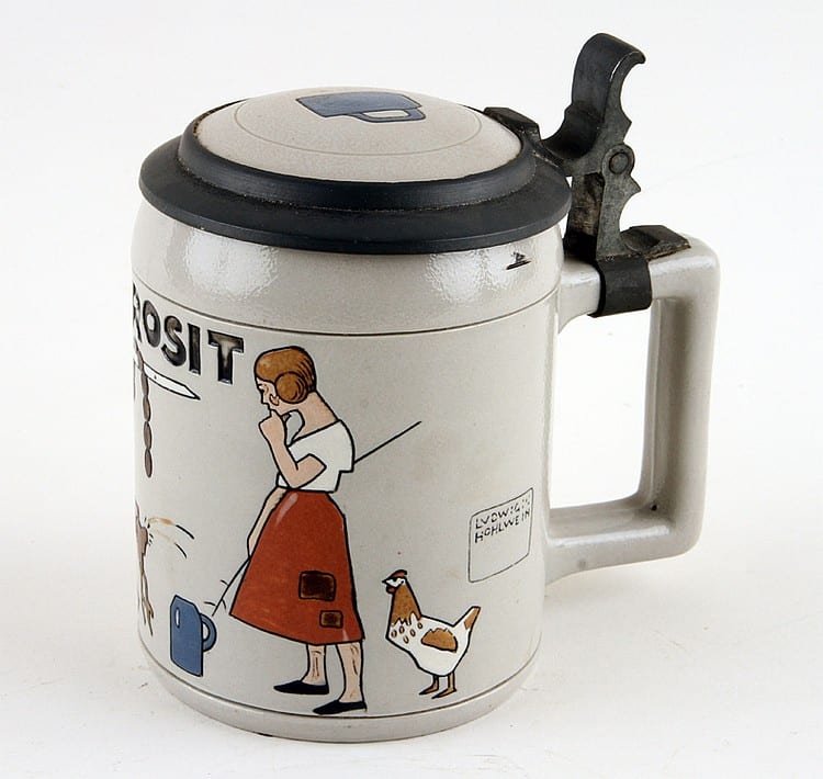 White ceramic beer stein with a hinged black lid and pewter-like handle, decorated with a woman holding a tool and a chicken.