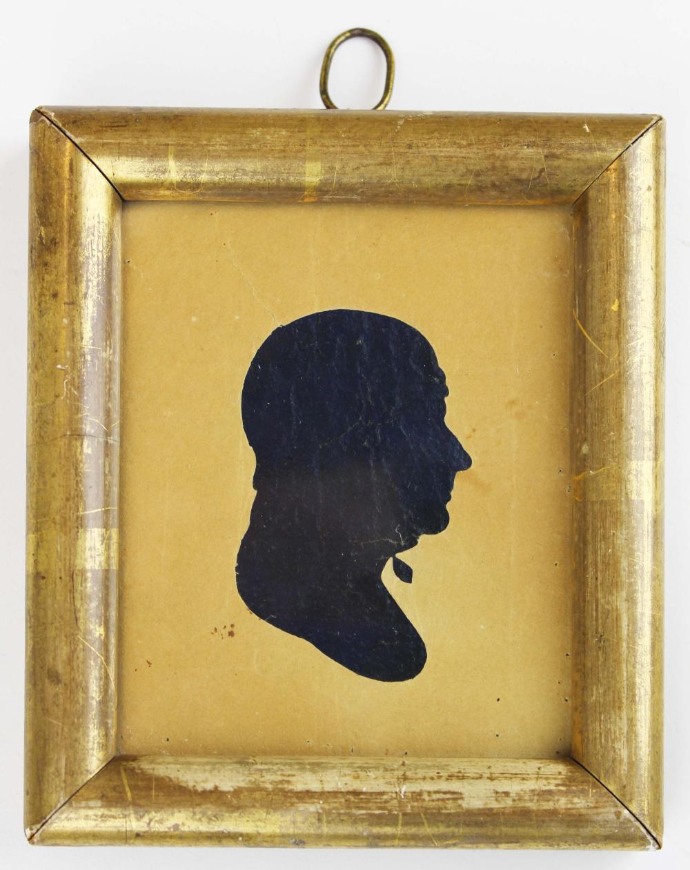 Framed black silhouette portrait of a woman in profile, facing right, shown on a beige background.