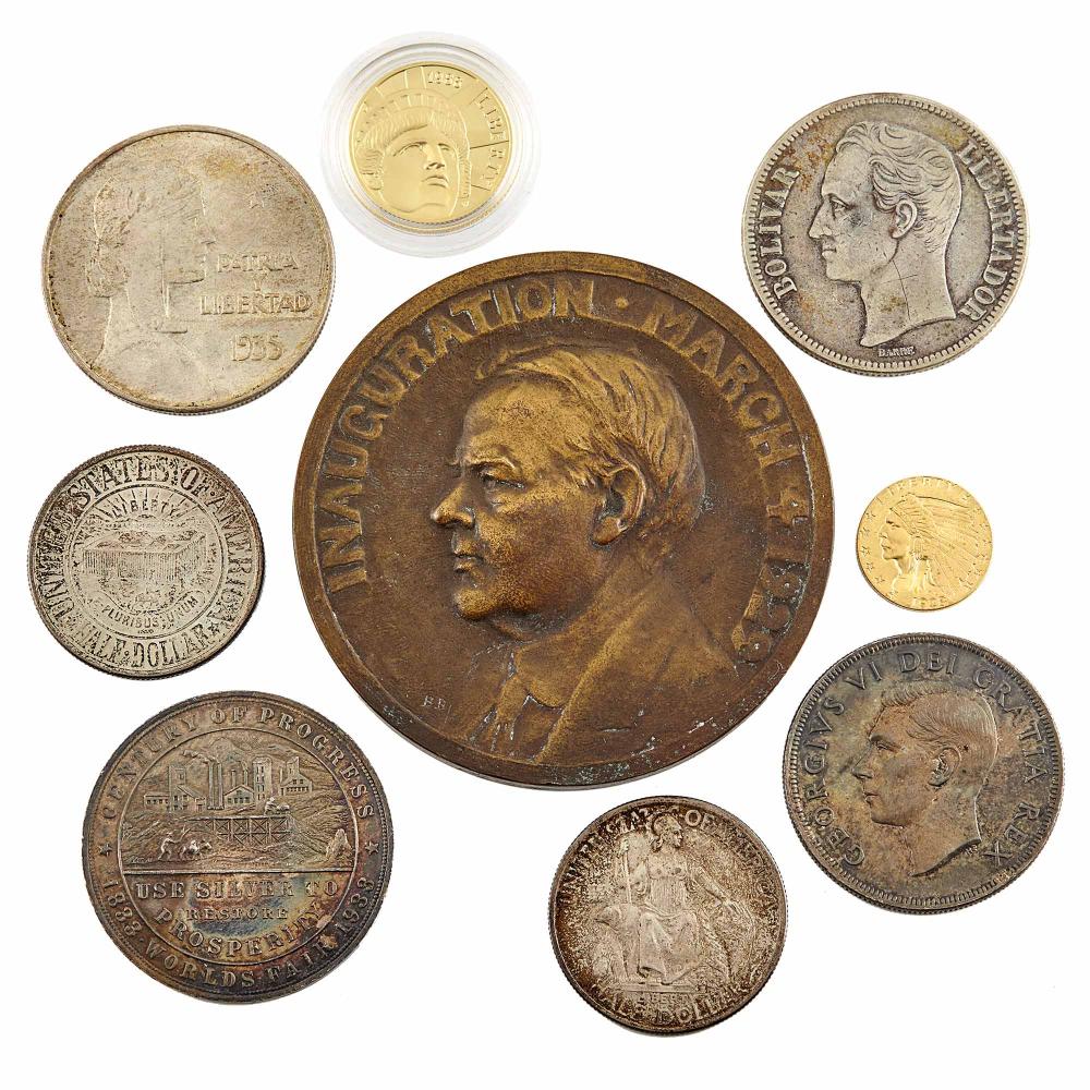 Group of mixed coins and coin medals on a white background, including large bronze portrait medal and several silver and gold-colored coins.