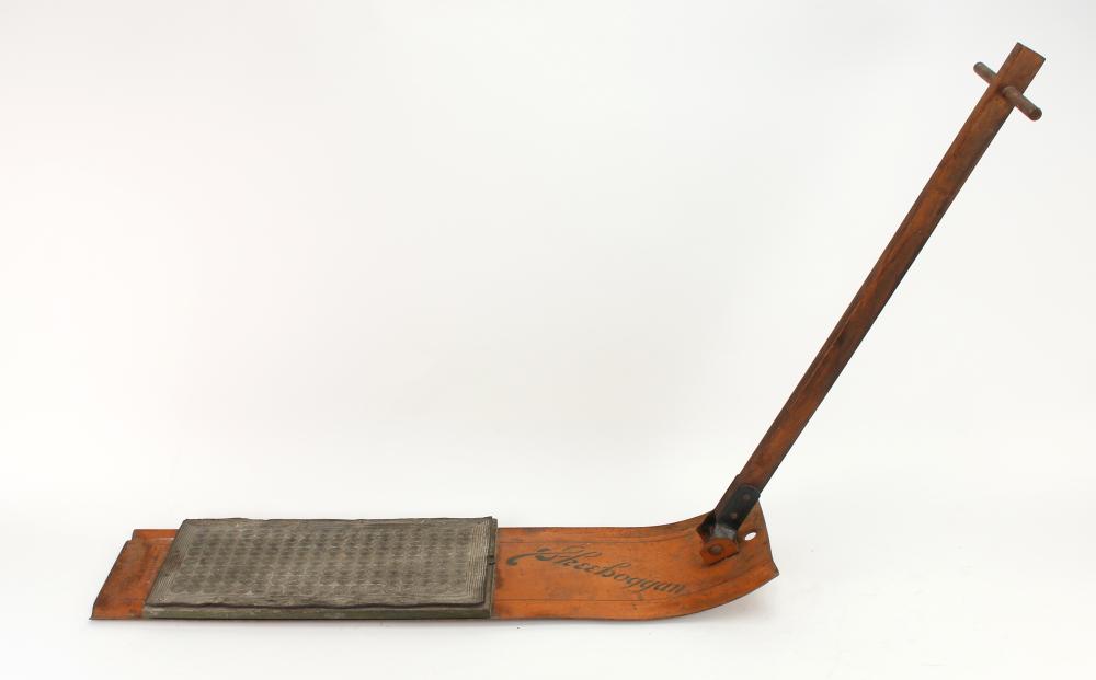 Wooden antique-style sled with an upright handle and a fabric-covered running board, shown against a plain background.
