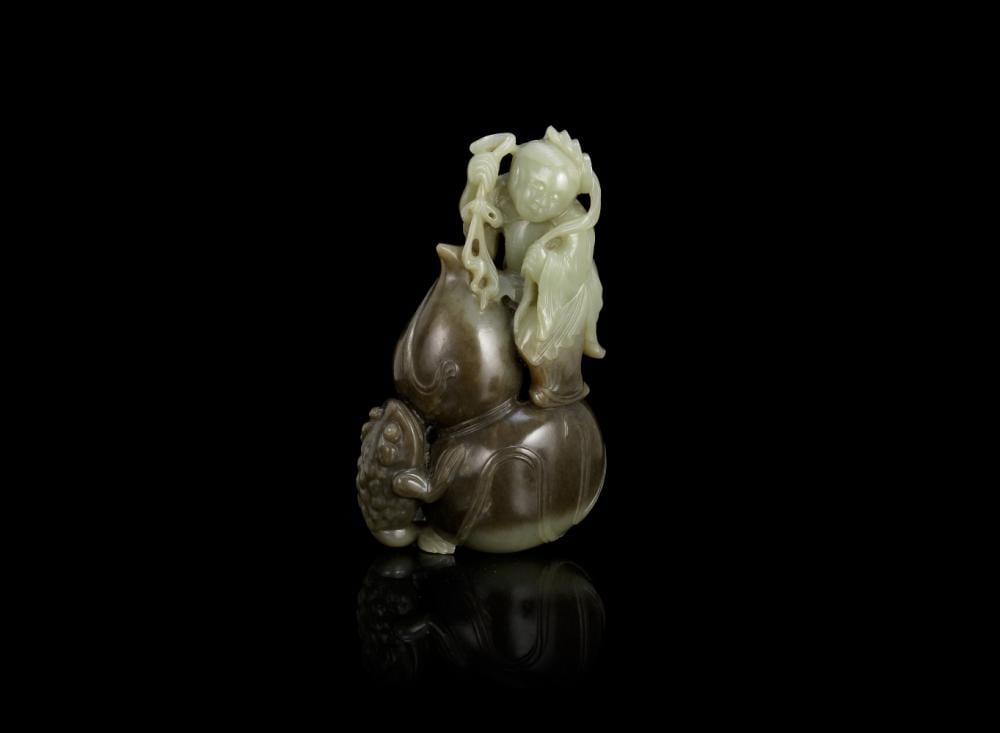 A Hai comparable auction result: a pale green and mushroom coloured jade liu hai group qing dynasty