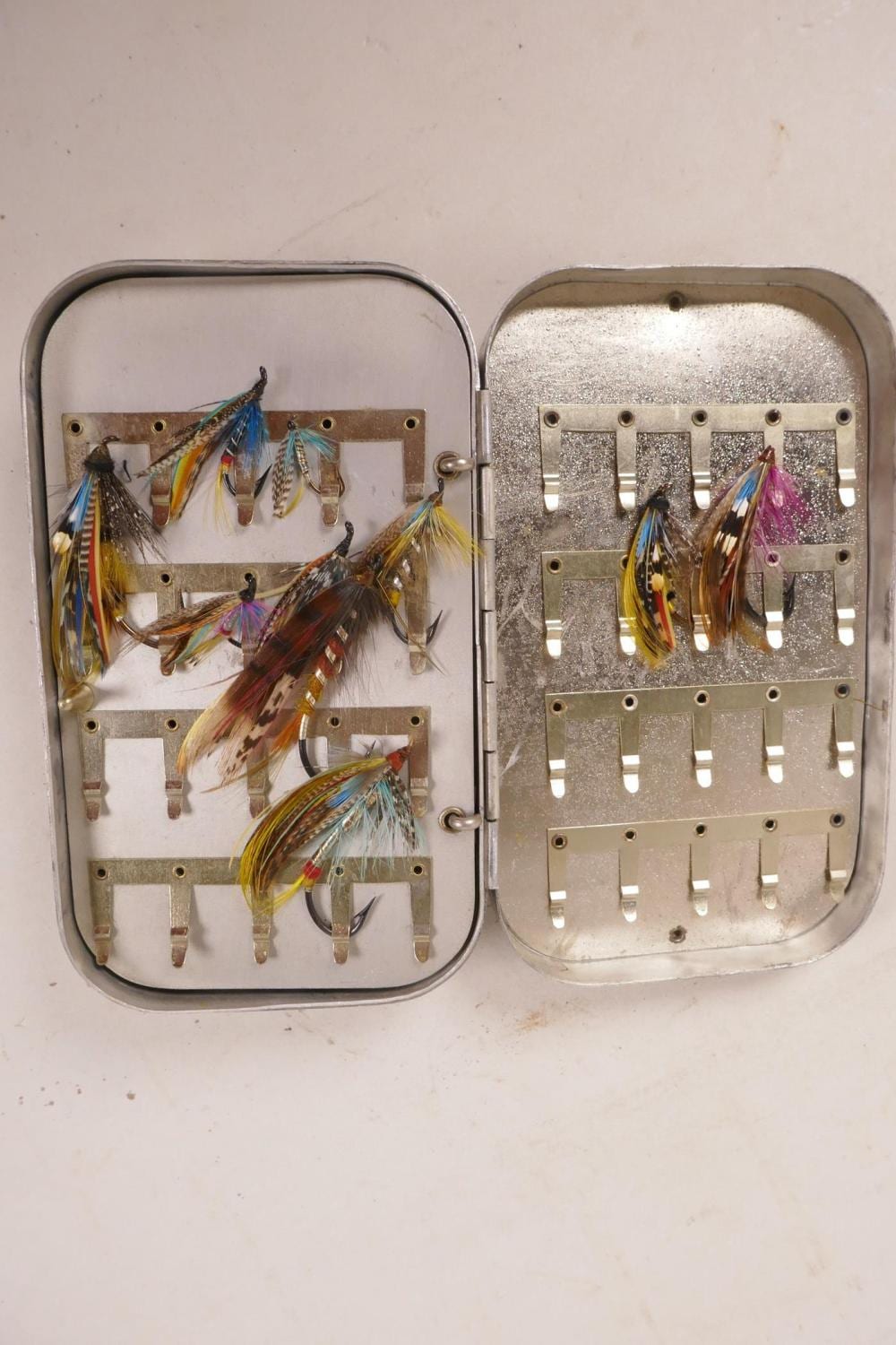 a vintage aluminium fly box containing multiple salmon flies · Crow's Auction Gallery Ltd · 2019-11-06 A. Salmon comparable auction result: a vintage aluminium fly box containing multiple salmon flies