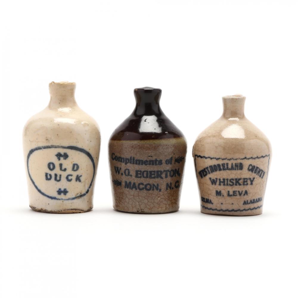 Three Miniature Advertising Whiskey Jugs sold by Leland Little Auctions, lot 230 — auction record photograph