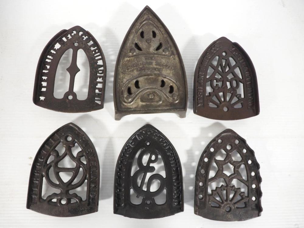 (6) Cast iron trivets sold by Chupp Auctions & Real Estate, LLC, lot 2441 — auction record photograph