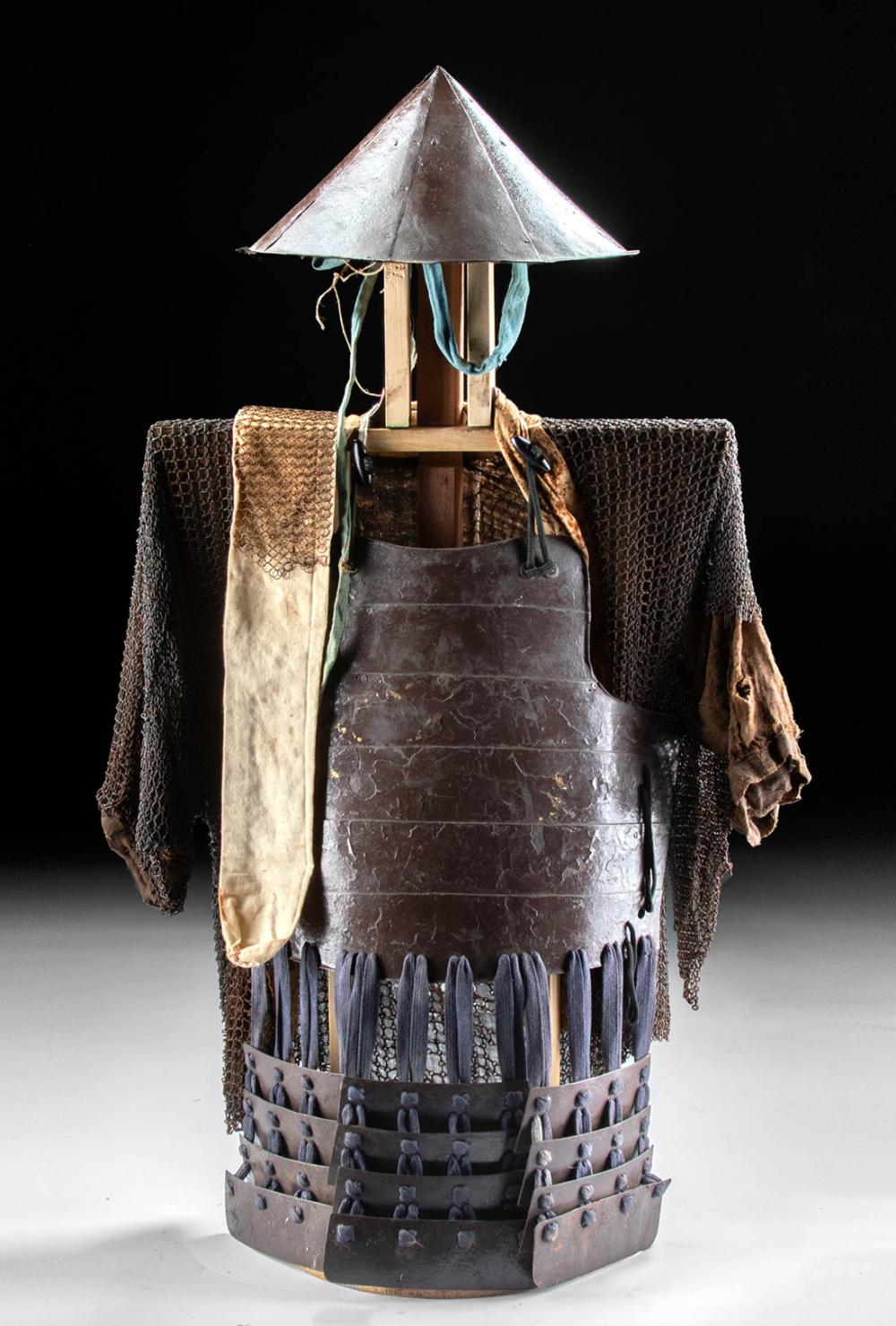 Japanese samurai style iron armor torso with attached chainmail sleeves and an open conical helmet/hat displayed on a stand, against a black background.