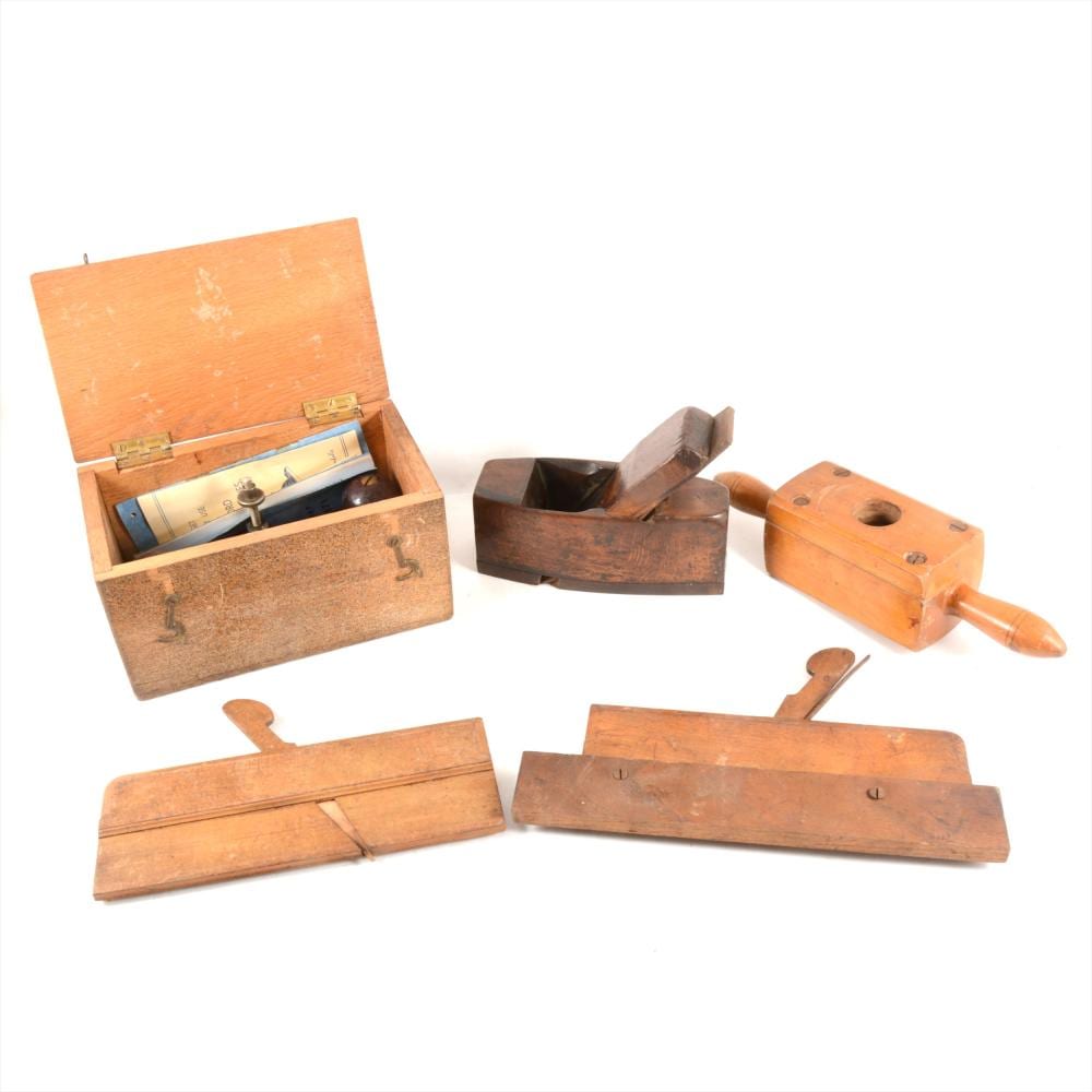 Set of antique-looking wooden hand planes and a screw-cutting plane with metal blades and an open wooden box, photographed on a white background.