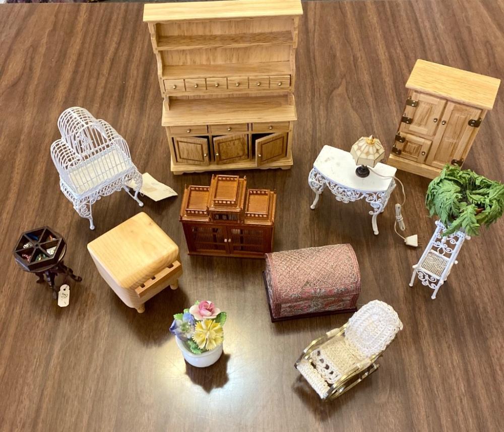 A collection of doll house furniture to include wirework birdcage, plant stand and side table; hoosier cabinet, butcher block, rocking chair, another birdcage, hand crafted wooden curiosity table (price tag $80; trunk... sold by Link Auction Galleries, lot 446 — auction record photograph