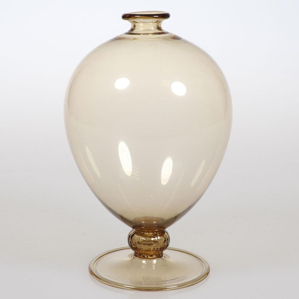 Amber-tinted glass vase with a rounded bulb body and narrow neck, photographed against a white background.