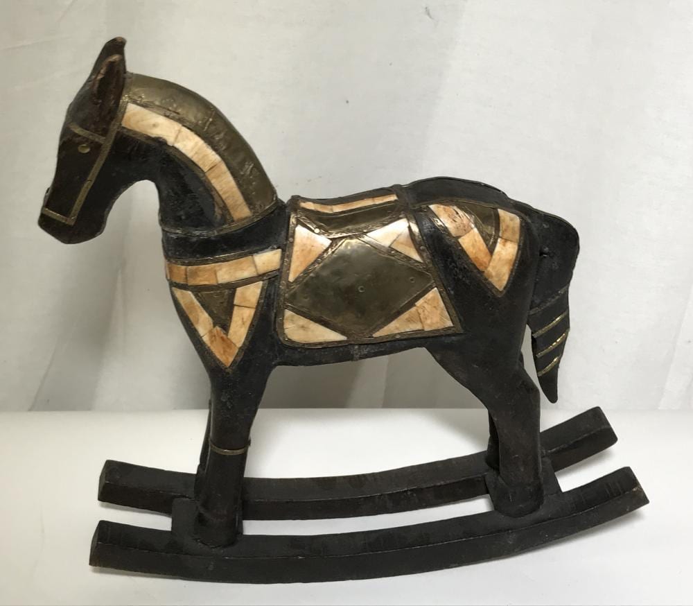 Wooden rocking horse figure with black-and-tan geometric inlaid pattern and bentwood rockers, photographed against a light background.
