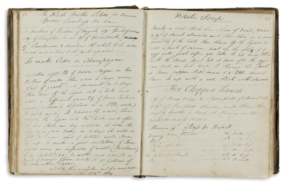 Open manuscript recipe book with handwritten text and headings on two pages, bound in a worn leather cover.