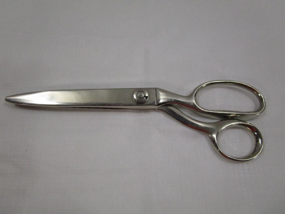 Metal scissors with two loop finger holes and long blades, shown on a plain gray background.