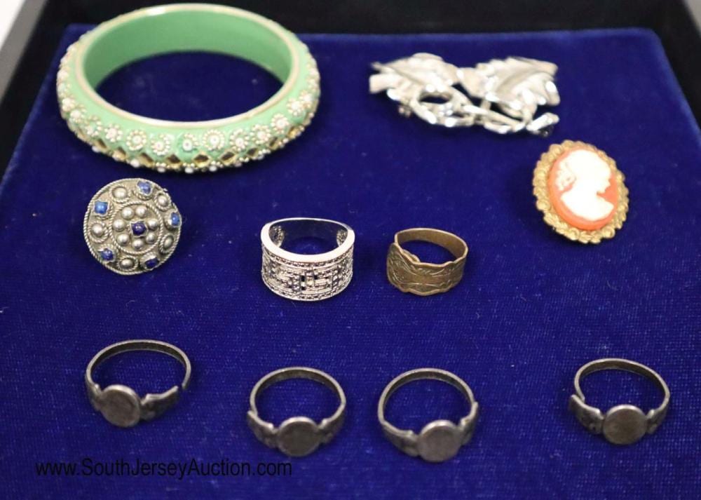 Group lot of vintage jewelry including 7 rings, brooch of leaves, cameo brooch, green Indian bracelet with gold tone and pearl style accents sold by South Jersey Auction by Babington Auction Inc., lot 519 — auction record photograph