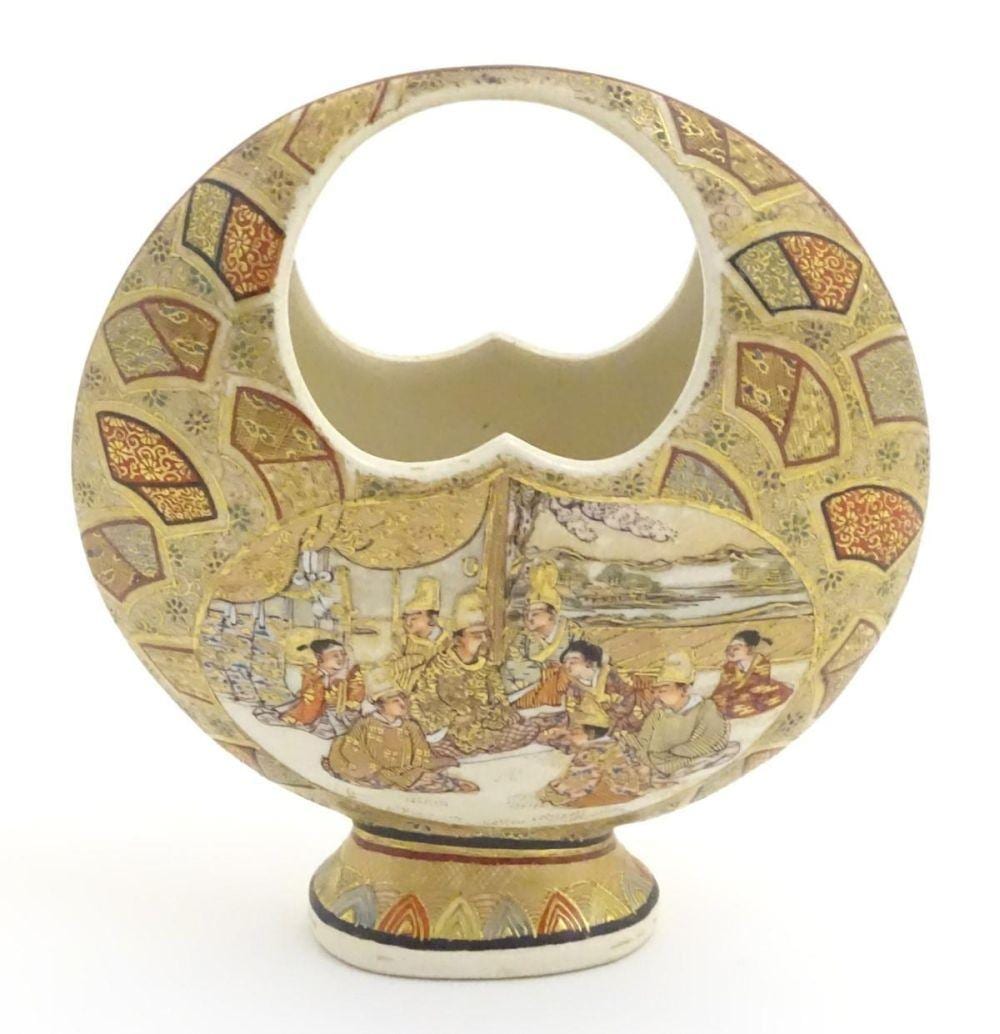 A Japanese satsuma moon basket vase with hand painted decoration depicting figures seated around imp sold by Claydon Auctioneers, lot 16A — auction record photograph