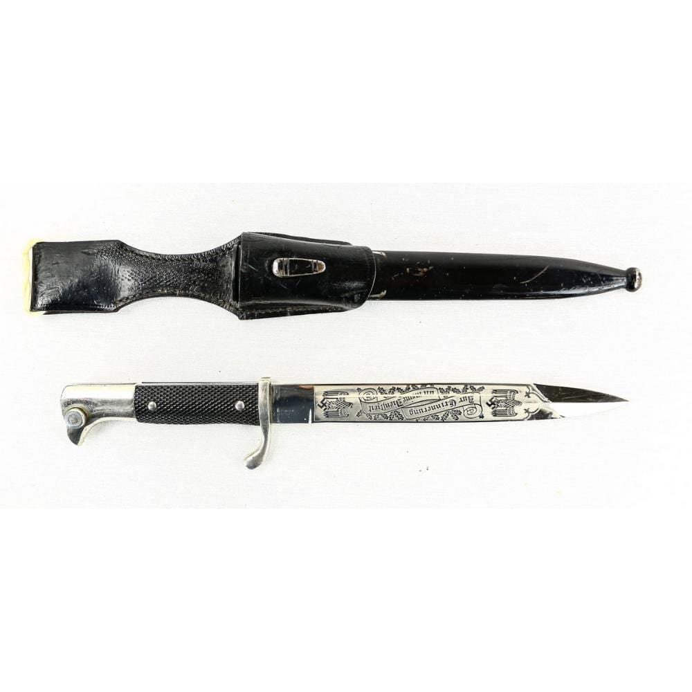 Two-part view of a black and silver dagger with a pointed metal blade and etched side handle guard.