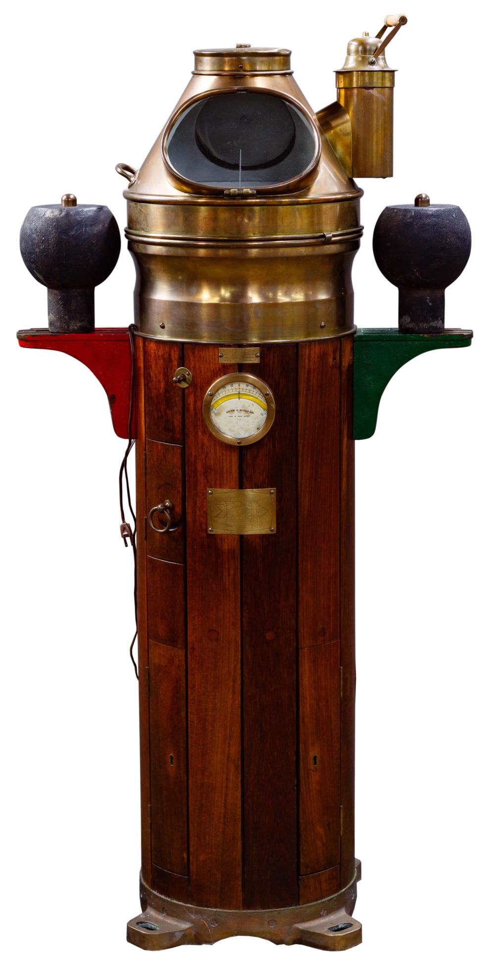 Brass and wood ship binnacle with globe-style compass window, side controls, and a round dial on the front.
