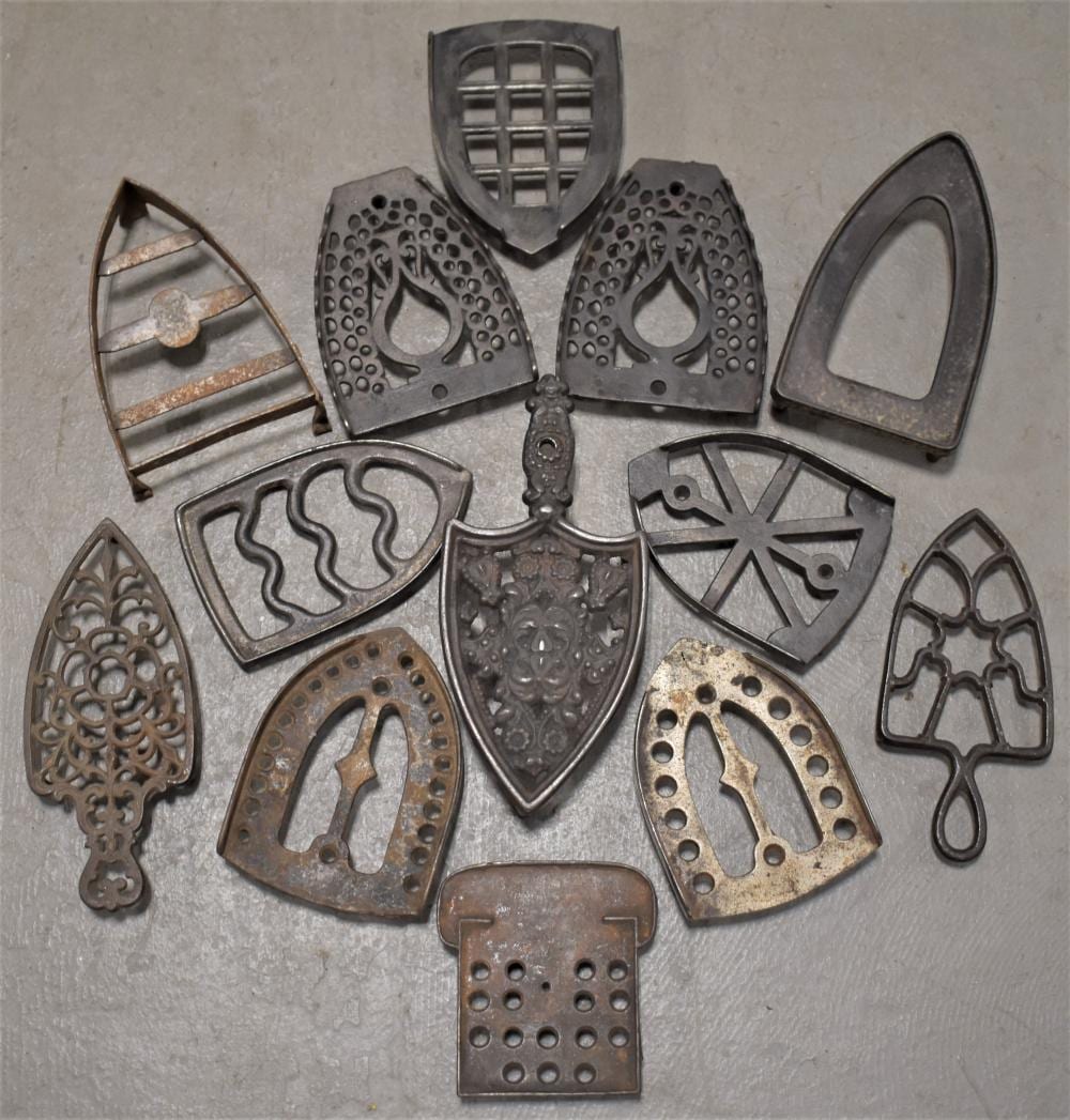 Lot (13) Cast Iron Trivets sold by Keene Auctions, lot 170 — auction record photograph