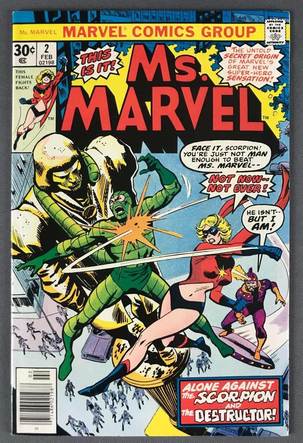 Comic book cover titled “Ms. Marvel” showing superhero characters battling a villain with speech bubbles and bold red letters.