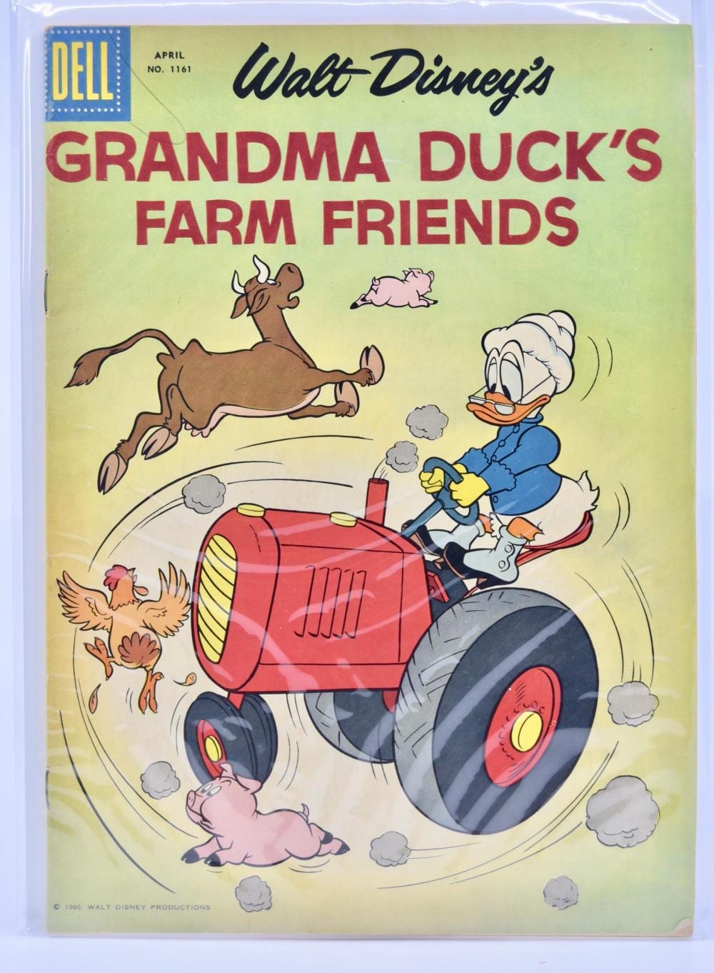 Comic book cover titled “Walt Disney’s Grandma Duck’s Farm Friends” from Dell, showing Grandma Duck on a red tractor with animals and farm friends.