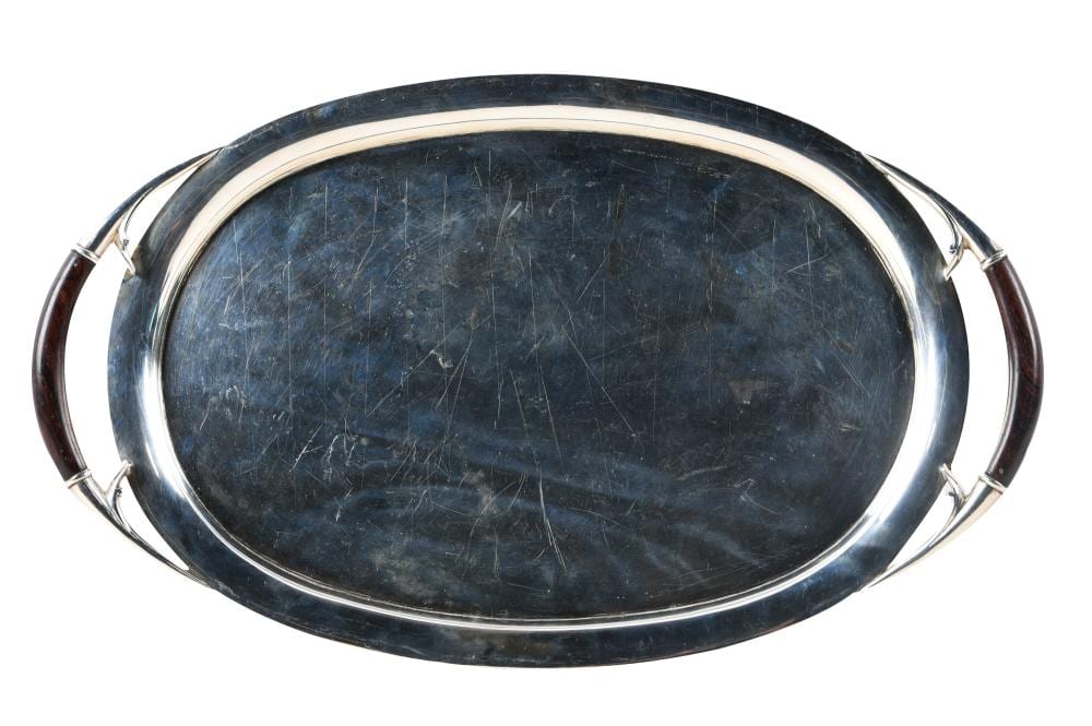 Oval metal serving tray with raised rim and handles on both sides, shown against a white background.
