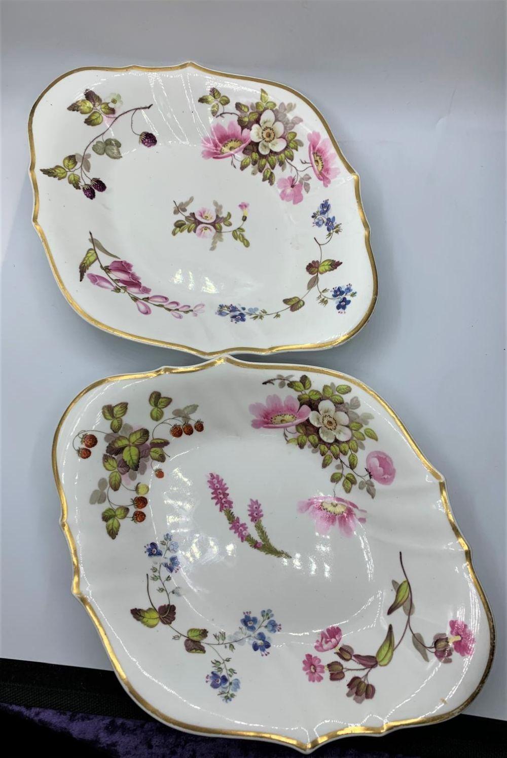 A. Daniel comparable auction result: a pair of h r daniel cusped shape serving dishes a few marks from use