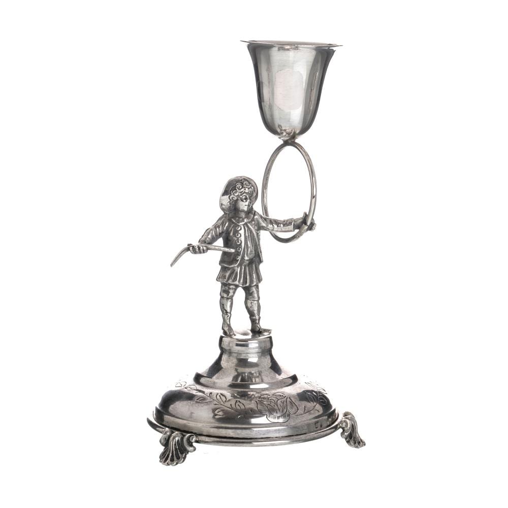 Silver-tone figure holding a loop with a cup above and a decorated base, shaped as a toothpick holder.