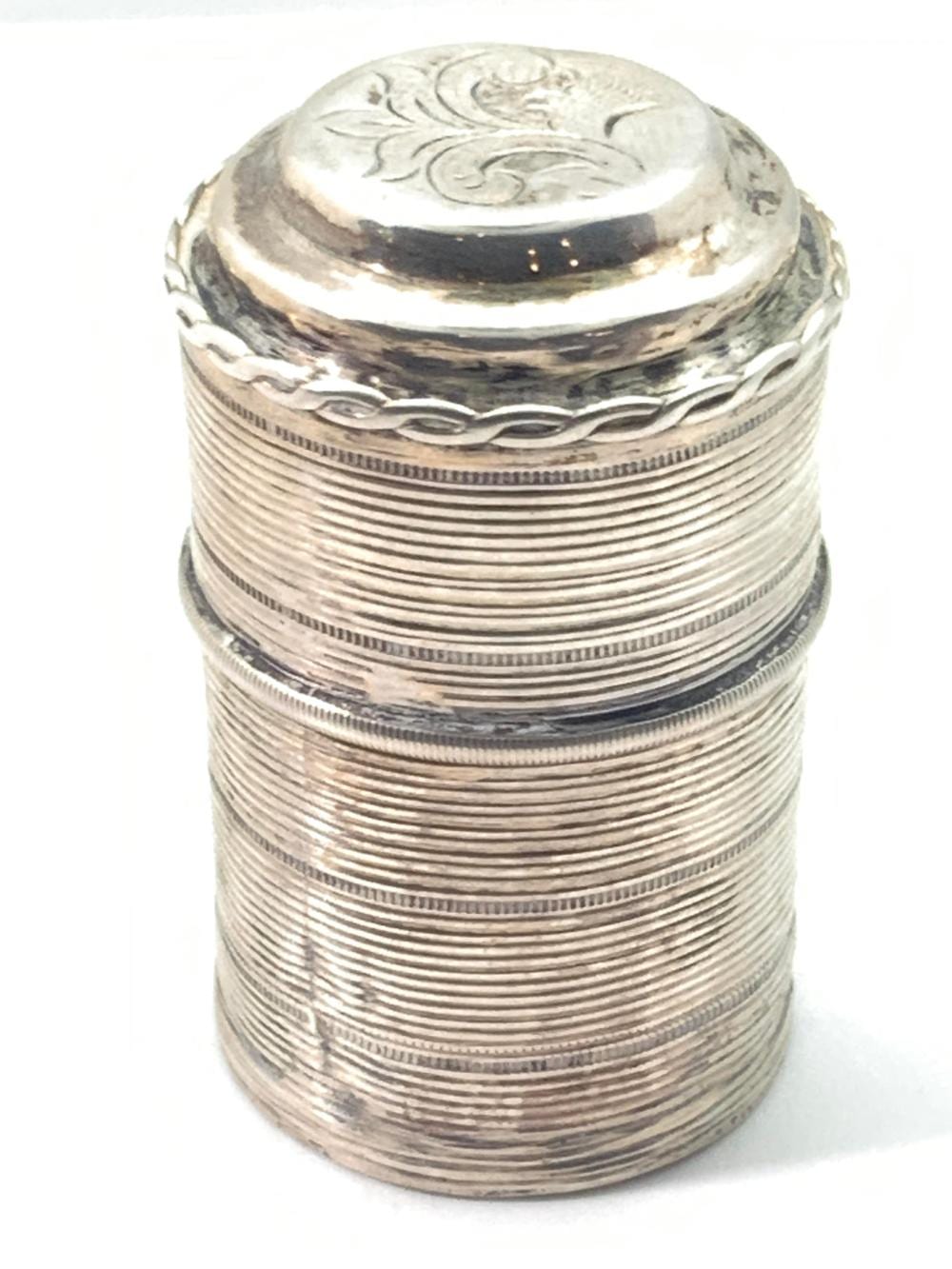 Antique-style silver hinged pill box with a ribbed body and engraved crest on the lid.