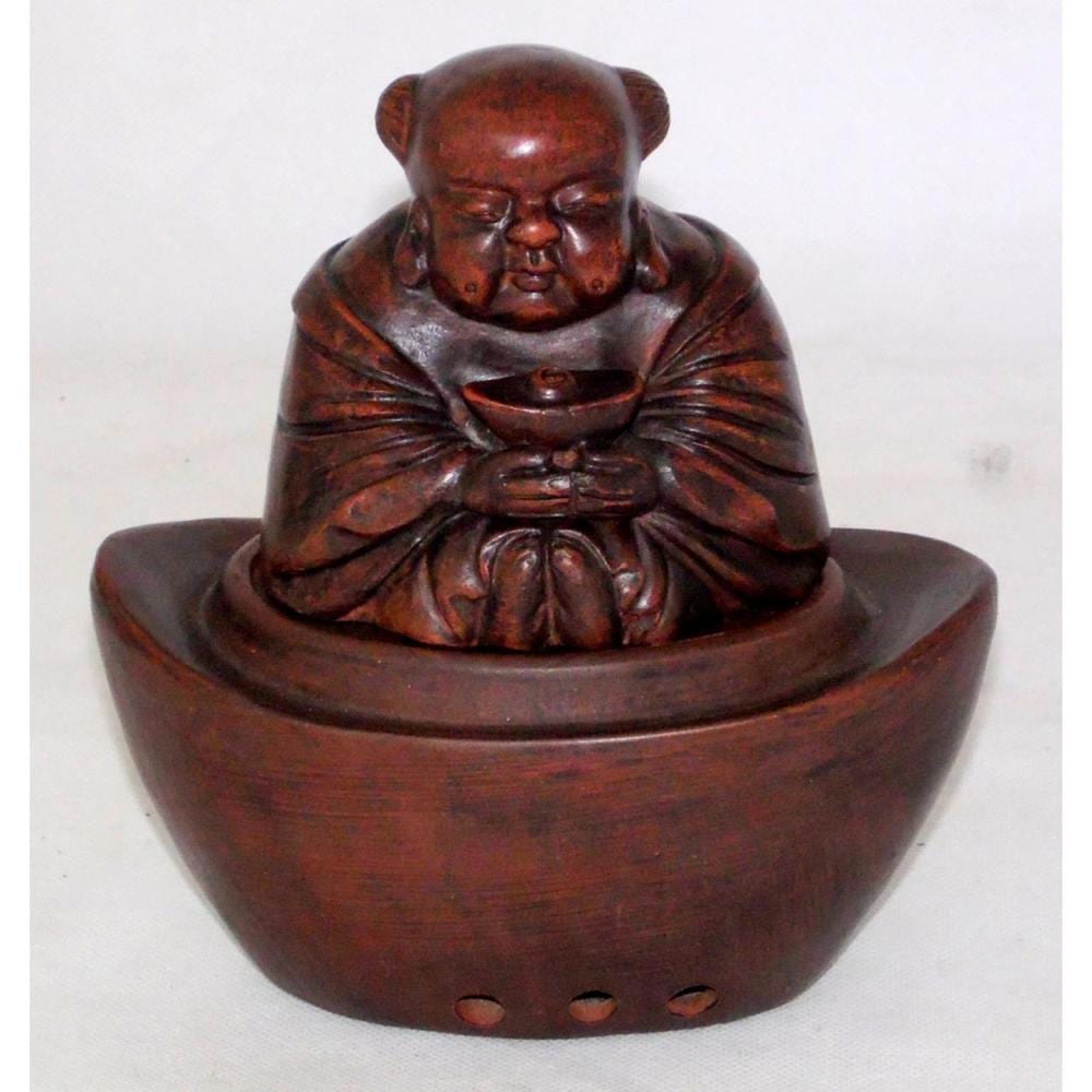 Hand-carved terracotta-style incense burner shaped like a seated laughing figure with arched hands and a circular base with three holes.