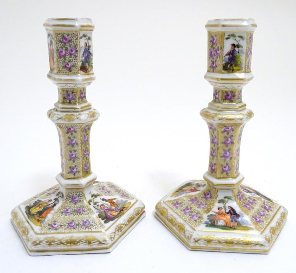A. Pain comparable auction result: a pair of berlin porcelain candlesticks on hexagonal bases with gilt and floral detail and hand pain
