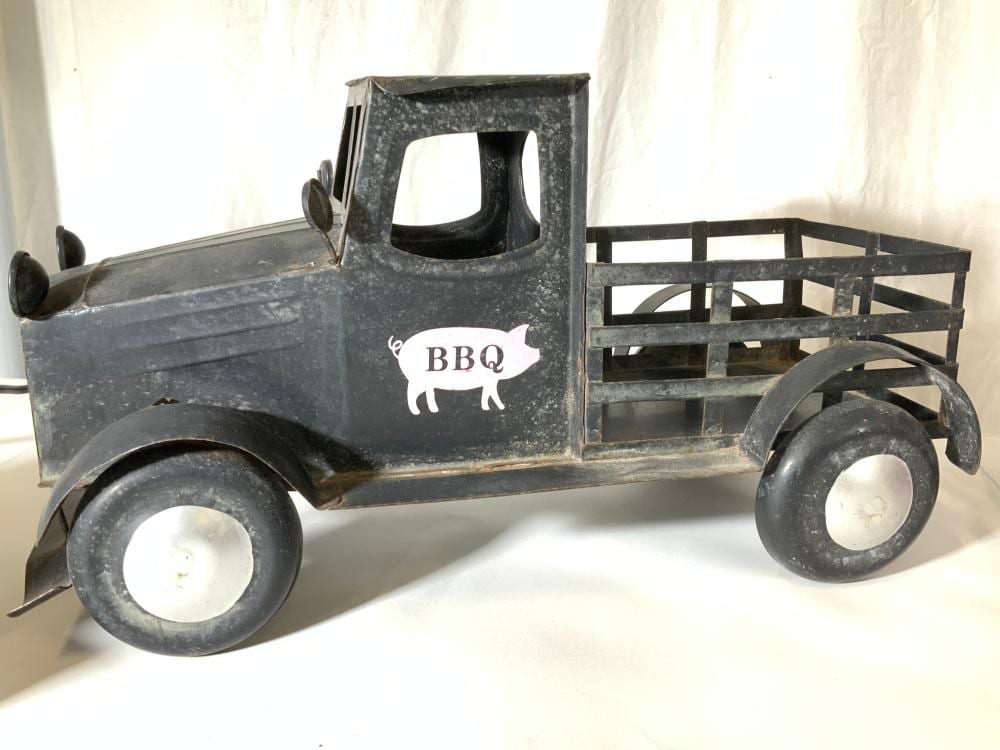 Vintage metal toy farm truck with flatbed and a “BBQ” pig logo on the side.