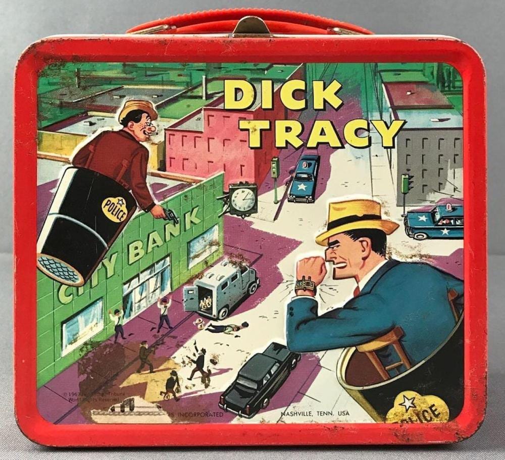 Red lunch box with Dick Tracy artwork showing a detective, police car, gang members, and city buildings on the front.