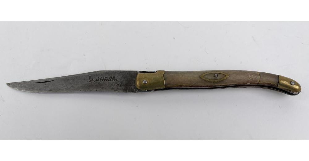 Open folding pocket knife with a gray metal blade and olive-green handle with rivets, laid horizontally against a white background.