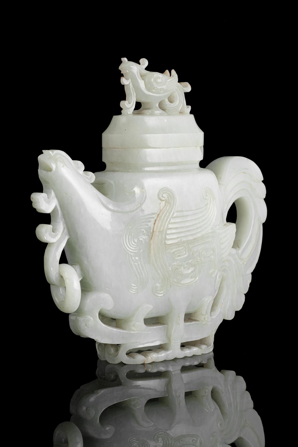 A RARE JADE 'PHOENIX' WINE POT AND COVER China, Qing Dynasty, 18th or 19th century Carved in a desirable stone. Shaped as a phoenix standing on its feet, the spout carved as the head, the neck with a loose ring, the handle carved as the tail whose sold by Adam's, lot 2 — auction record photograph