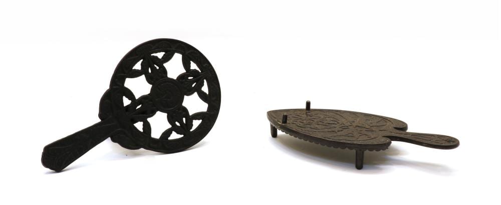 Two cast iron trivets, sold by Sworders, lot 84 — auction record photograph
