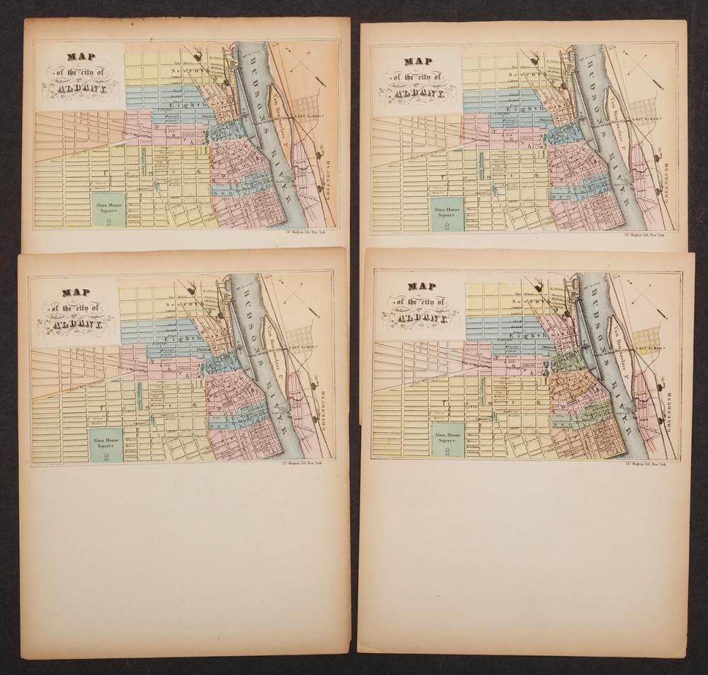 Four vintage city map sheets showing labeled blocks and waterways, arranged in a two-by-two layout on a dark background.