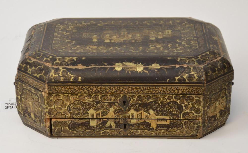 Rectangular ornate lacquer and gilt sewing box with hinged lid and keyhole, decorated with gold scrolling motifs and a landscape panel.