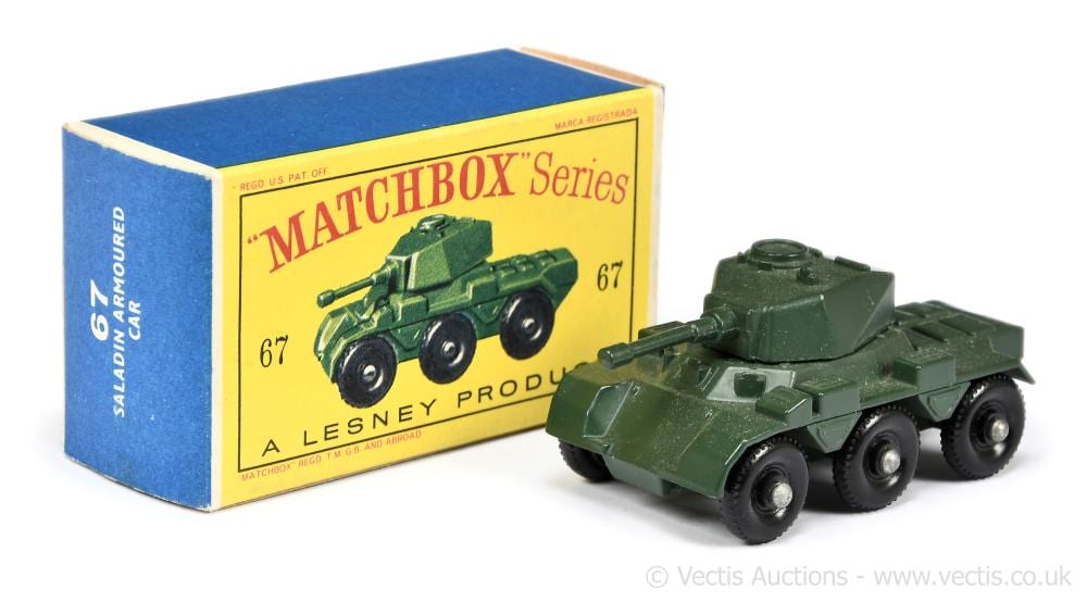 Green toy armored car with wheels, next to a Matchbox Series box labeled “67”.