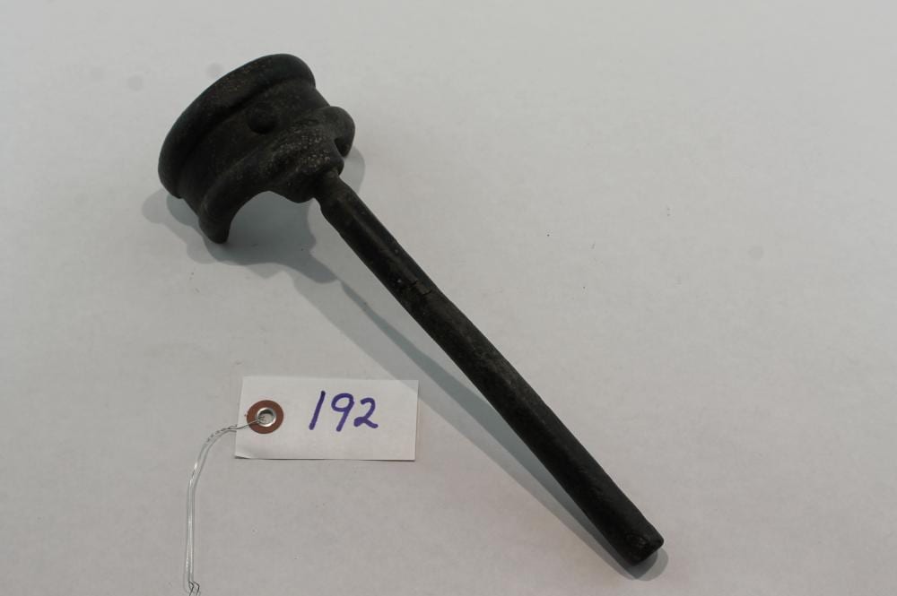 Black metal pin wrench with a curved handle and a head for inserting a pin, shown on a light background.