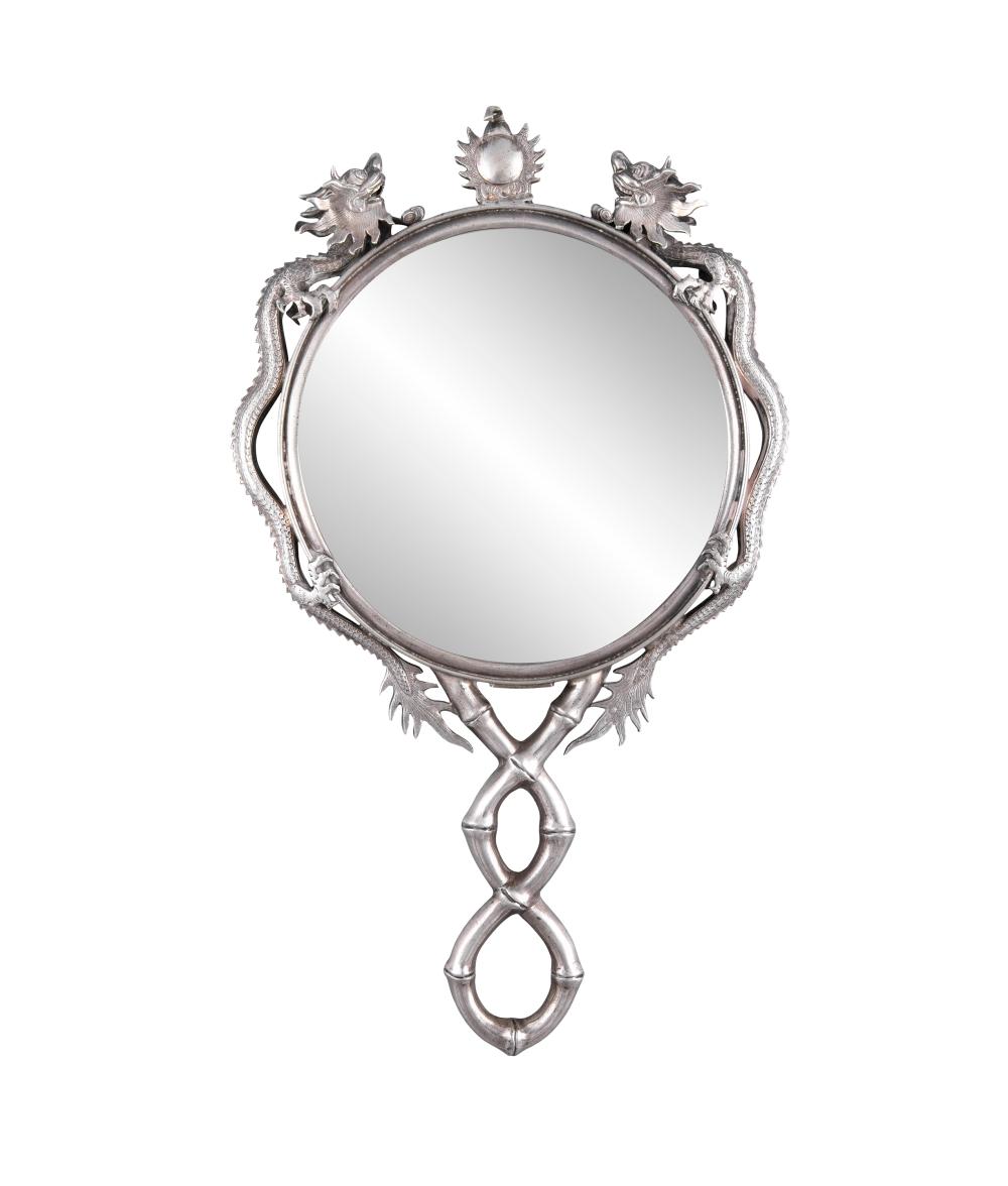 A CHINESE EXPORT SILVER HAND MIRROR BY WANG HING & CO Hong Kong, China, Circa 1900 The circular hand mirror surrounded by two dragons chasing a flaming pearl, the handle formed as entwined bamboo stalks, marked on mirror frame: “WH, “90” and uniden sold by Adam's, lot 142 — auction record photograph