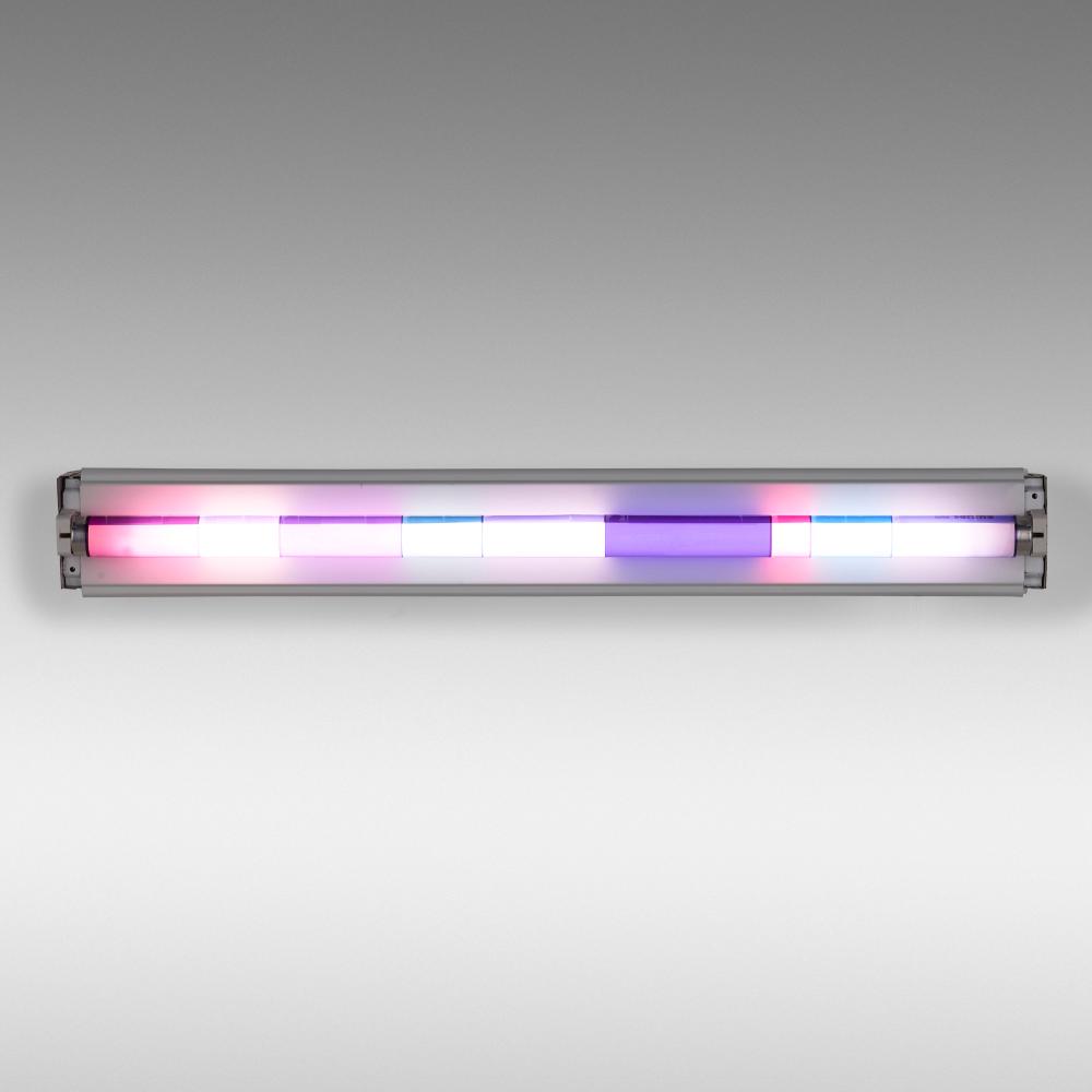 Rectangular wall-mounted light fixture with glowing white, pink, purple, and blue horizontal bars behind a translucent cover.
