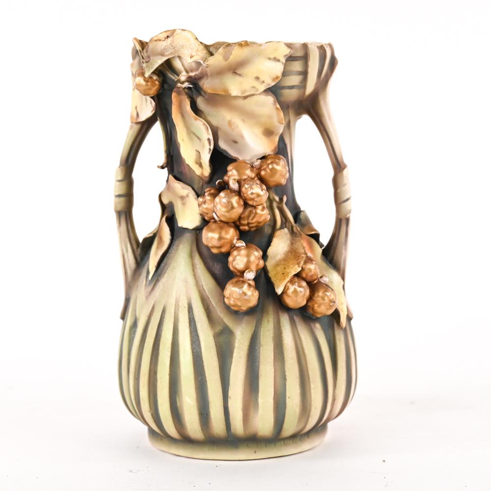 Decorative porcelain vase with ribbed blue body and raised floral clusters in brown along the front.