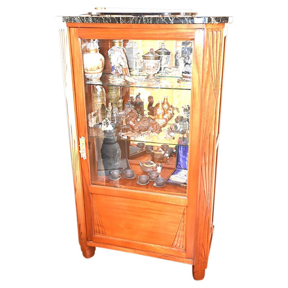 A fine quality French art deco walnut single door vitrine, having carved sides and green marble top. sold by Christian McCann Auctions, lot 120 — auction record photograph