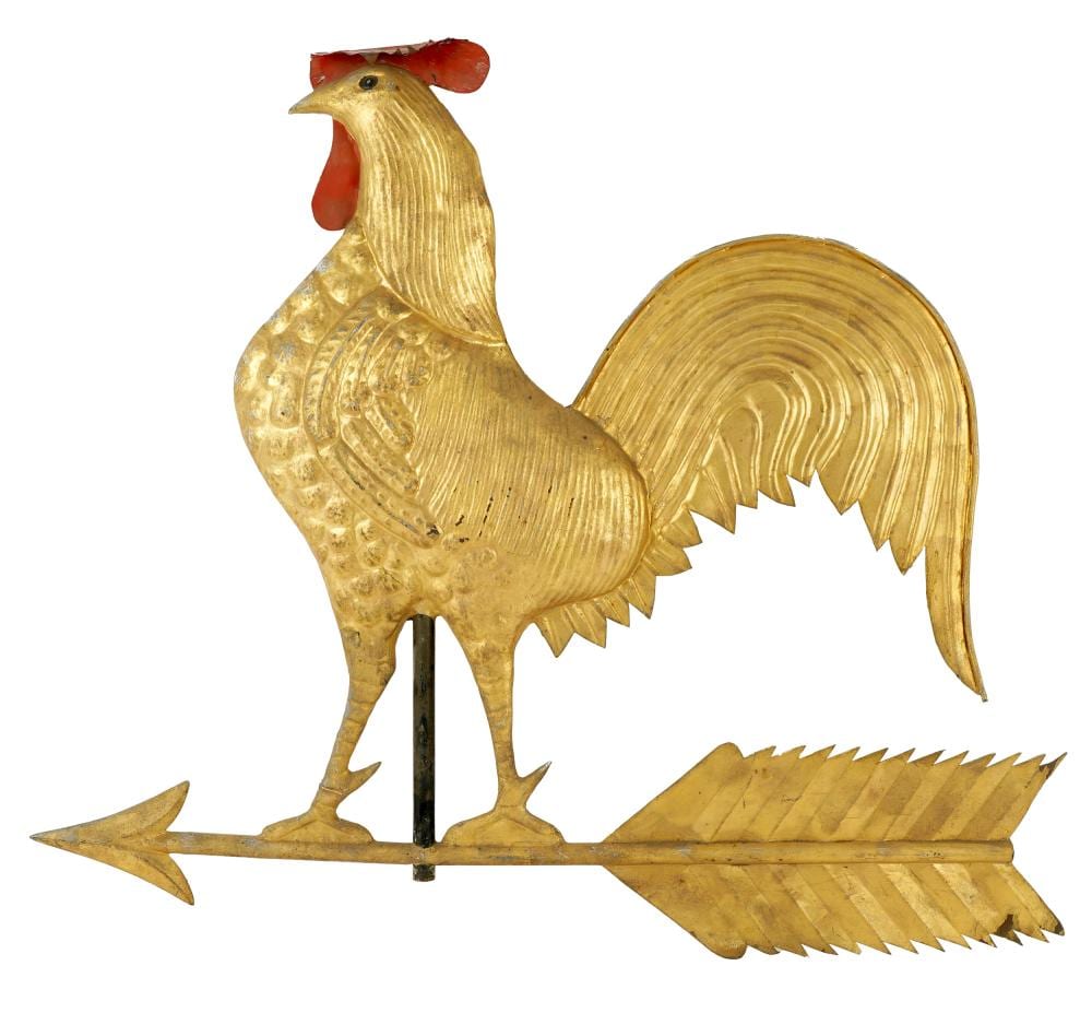Gold metal rooster weathervane with a red comb and painted detailing, shown with an arrow-shaped tail on a white background.