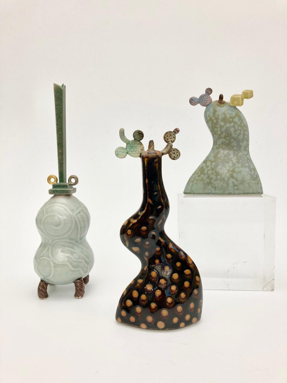 Adrian A Saxe comparable auction result: adrian a saxe american born 1943 two cactus oil lamps and a flower vase glazed porcelain stoneware lusters and mixed media o