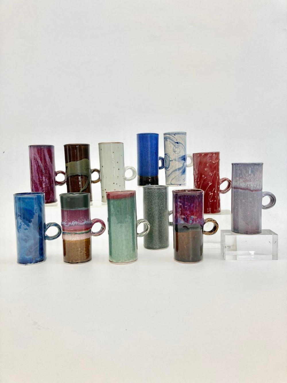 Adrian A Saxe comparable auction result: adrian a saxe american born 1943 set of 12 tall pottery cups circa 1975 each cup is glazed differently and individually signed s