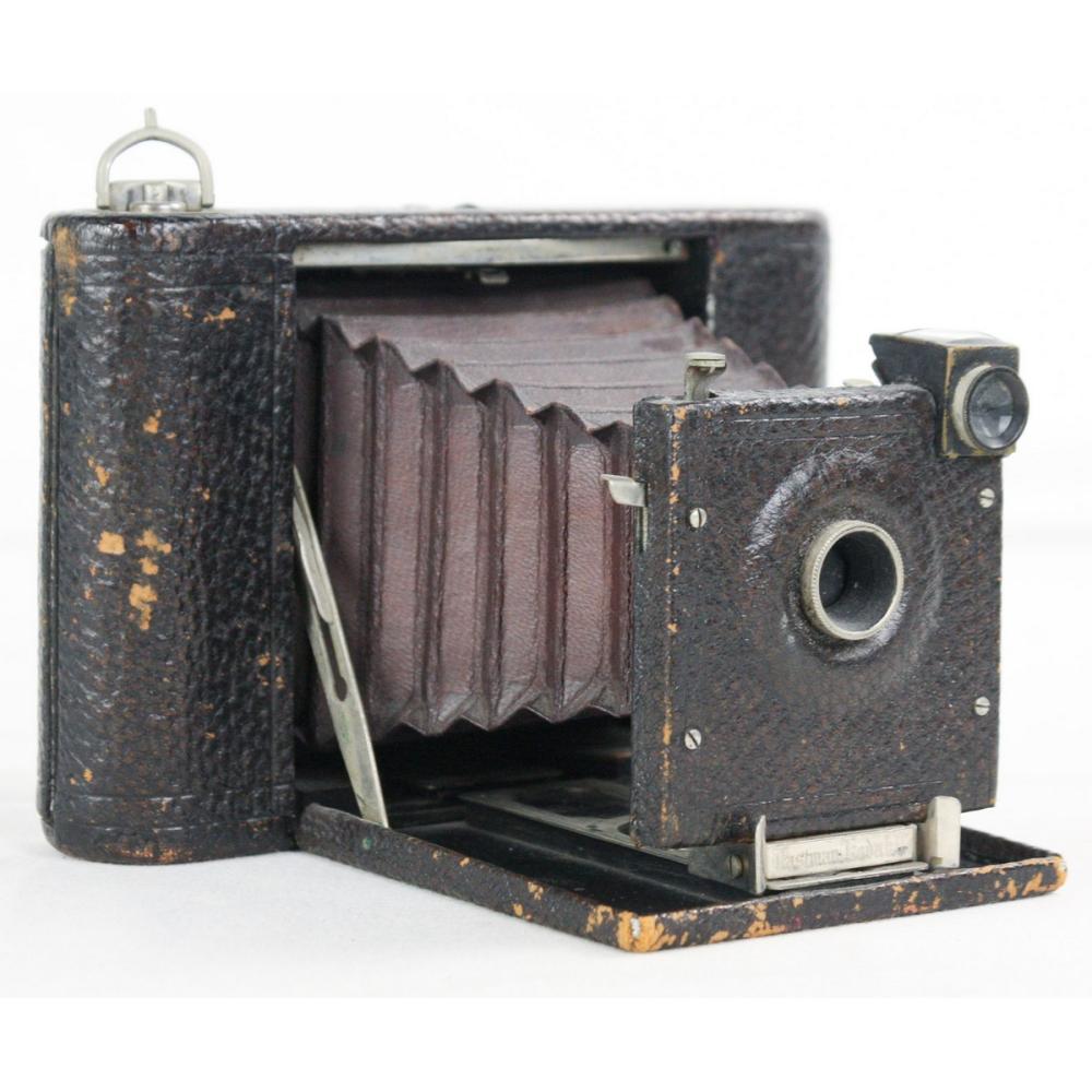 Vintage Kodak pocket folding camera with leather-like case open, showing accordion bellows and lens front.