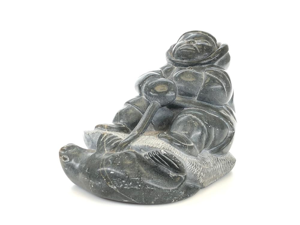 SIGNED INUIT HAND CARVED SOAPSTONE SEAL HUNTER SCULPTURE sold by Bradford's, lot 1299 — auction record photograph