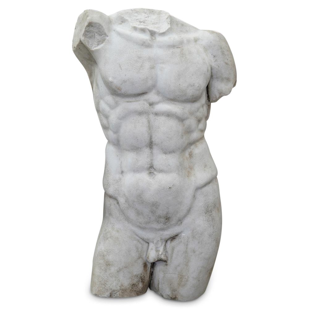 White stone sculpture of a nude male torso with draped hip details, photographed against a plain white background.
