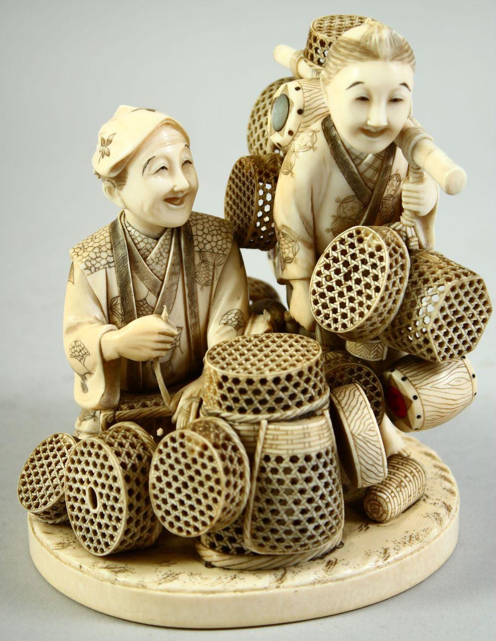 Frans Xaver Hendrik Verbeeck comparable auction result: a japanese meiji period carved ivory okimono of two basket sellers the two figures completely surrounded by f
