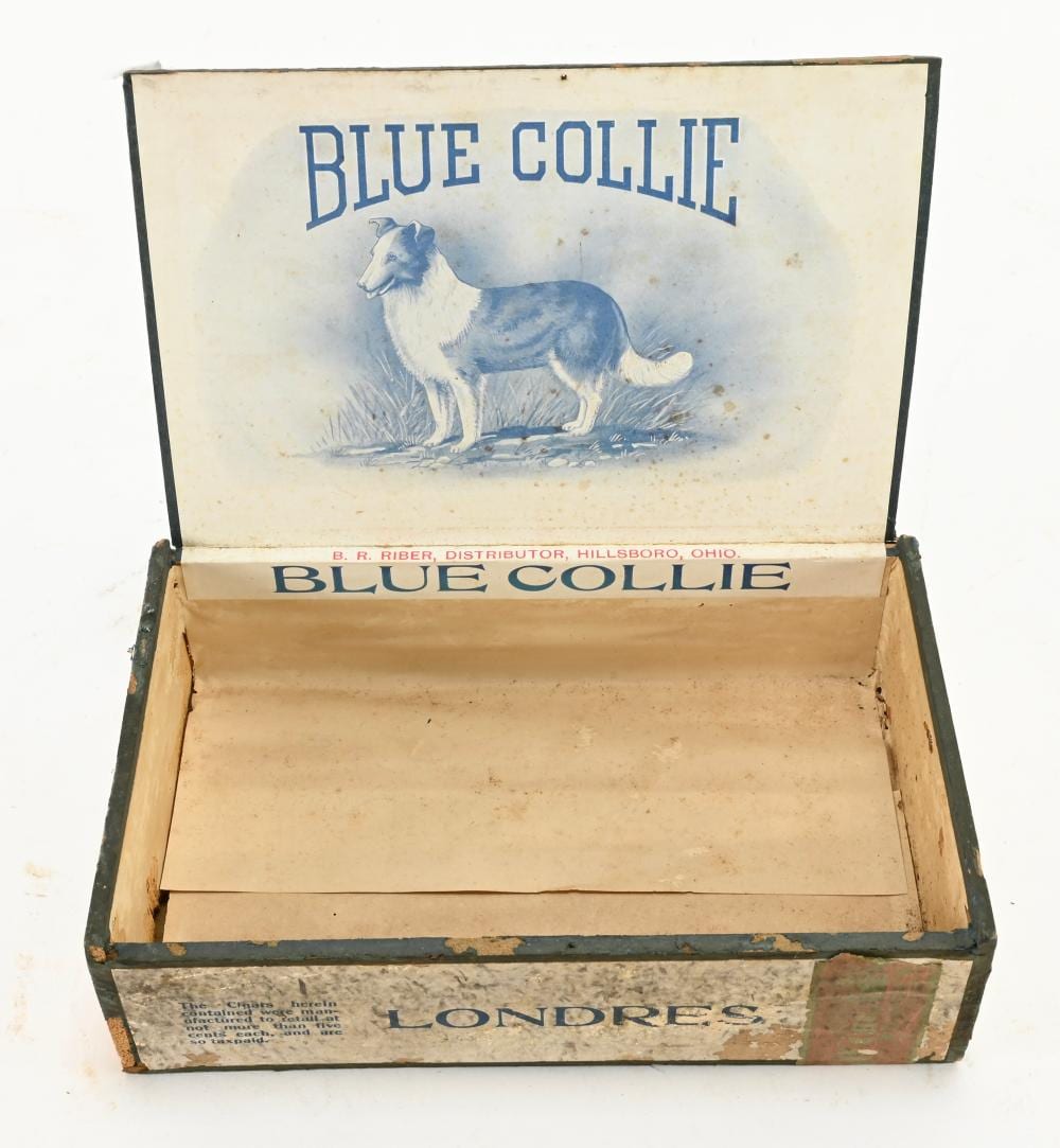 Open blue-and-white cigar box with a painted blue collie dog on the lid and “BLUE COLLIE” text across the top.