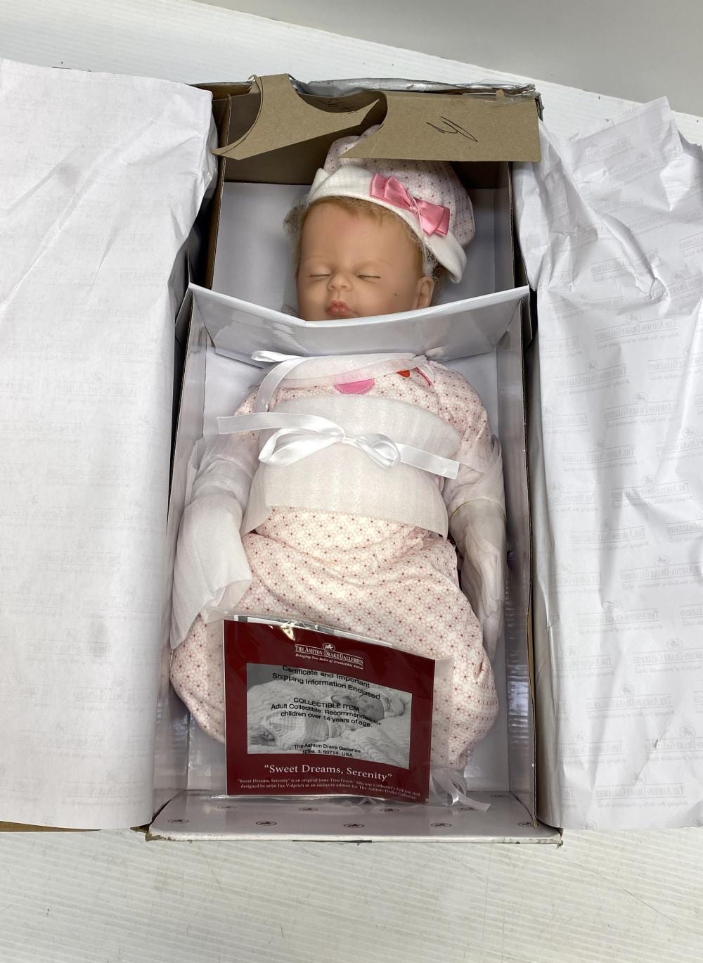 A collectors doll marked The Ashton Drake Galleries sold by Theodore Bruce Auctioneers & Valuers, lot 4076 — auction record photograph